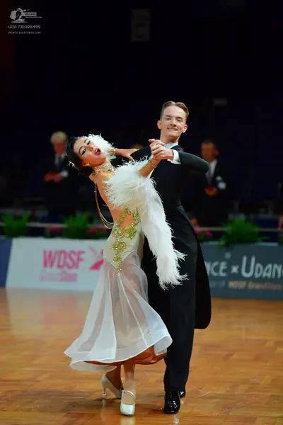 Dancesport competitor: Male dancer: black suit with a white shirt and black bowtie