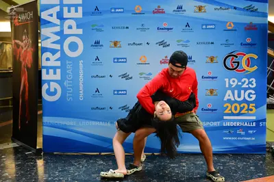 Dancesport competitor: Male dancer: red long-sleeved shirt and olive green shorts