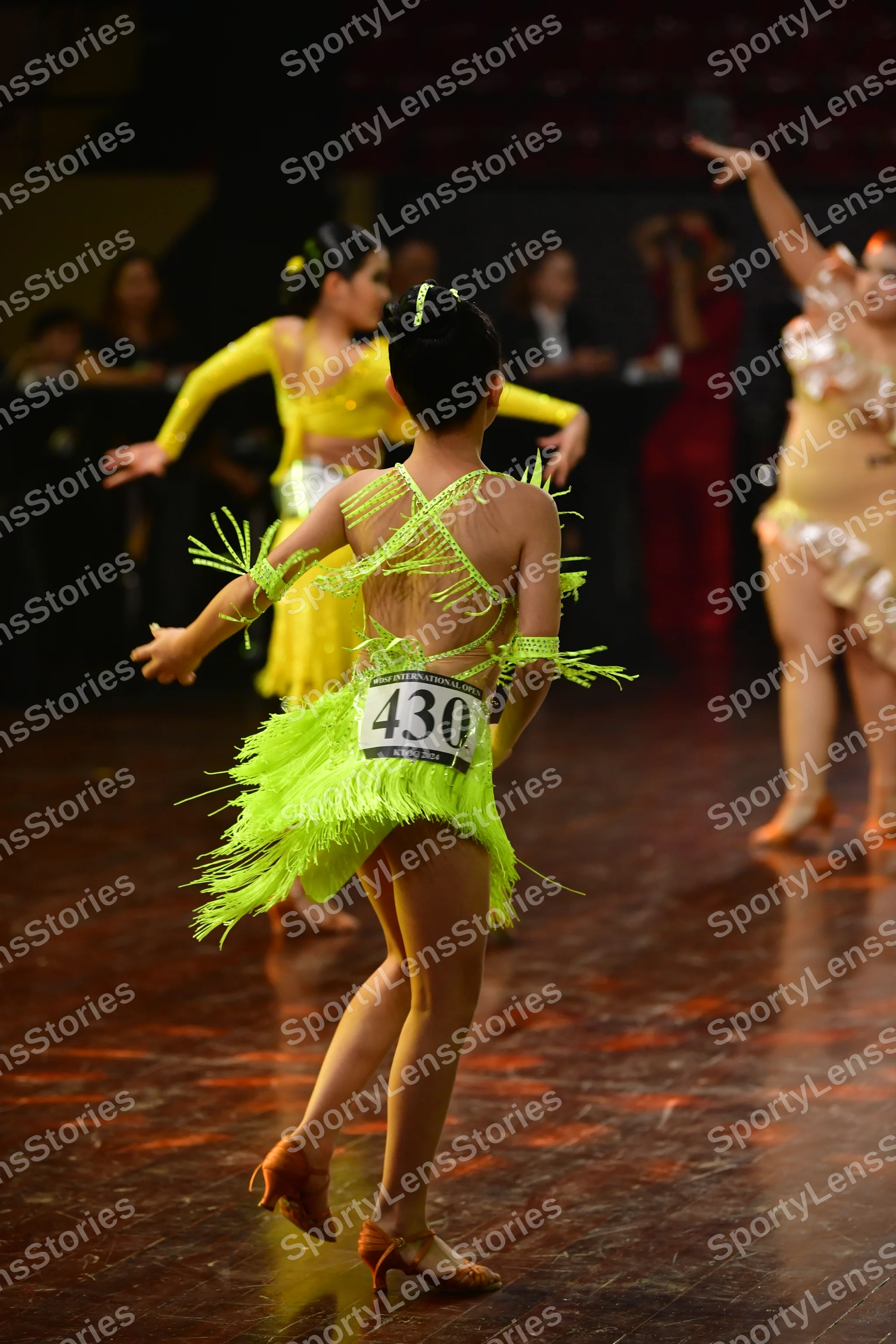 Dancesport competitor #430: Female dancer 1: bright lime green Latin dress with long fringe