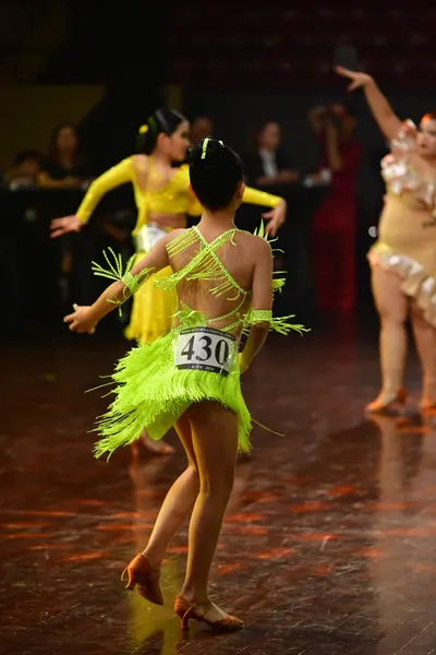 Dancesport competitor #430: Female dancer 1: bright lime green Latin dress with long fringe