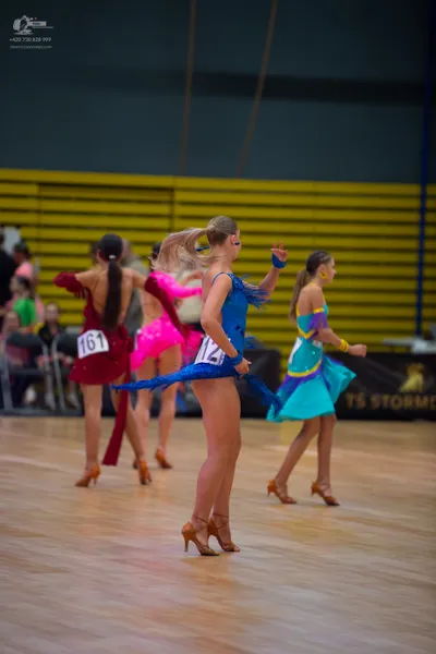 Dancesport competitor #061: ** Red Latin dress
*   **Color:** Deep Red
*   **Fabric:** Appears to be satin o