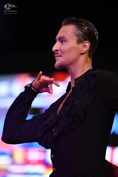 Dancesport competitor: Male:** Black tailsuit with sequin lapels