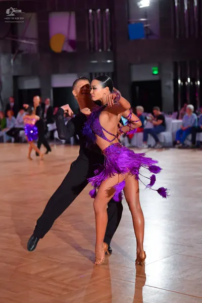 Dancesport competitor: Male dancer: black long-sleeved top and black trousers