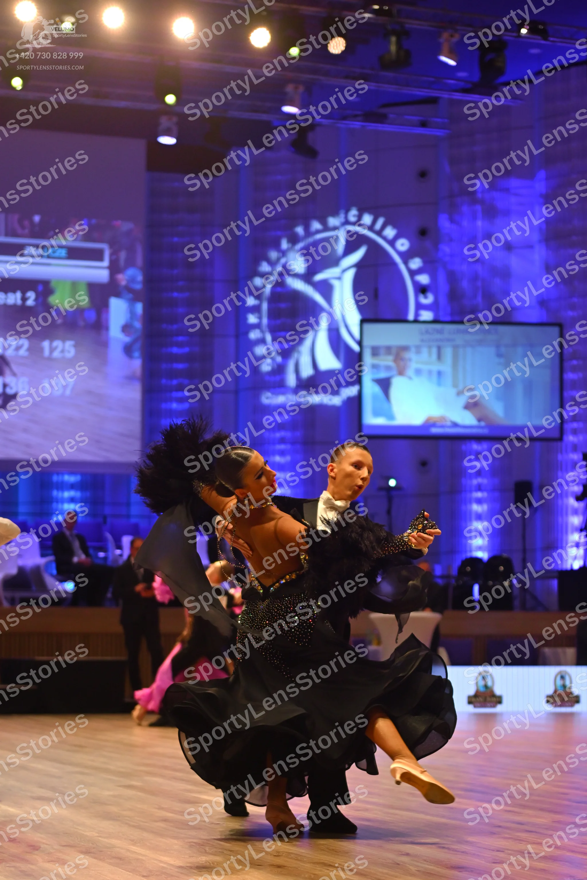 Dancesport competitor: Female dancer: black ballgown with a sequined bodice and large, voluminous black