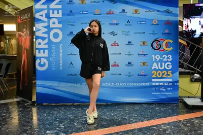 Dancesport competitor: Female dancer: black jacket and black shorts