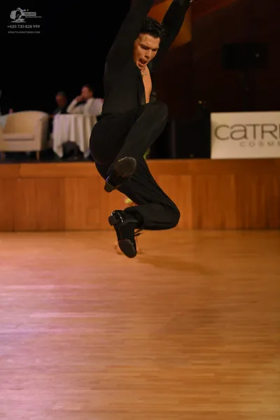 Dancesport competitor: Male dancer: black long-sleeved top and black trousers