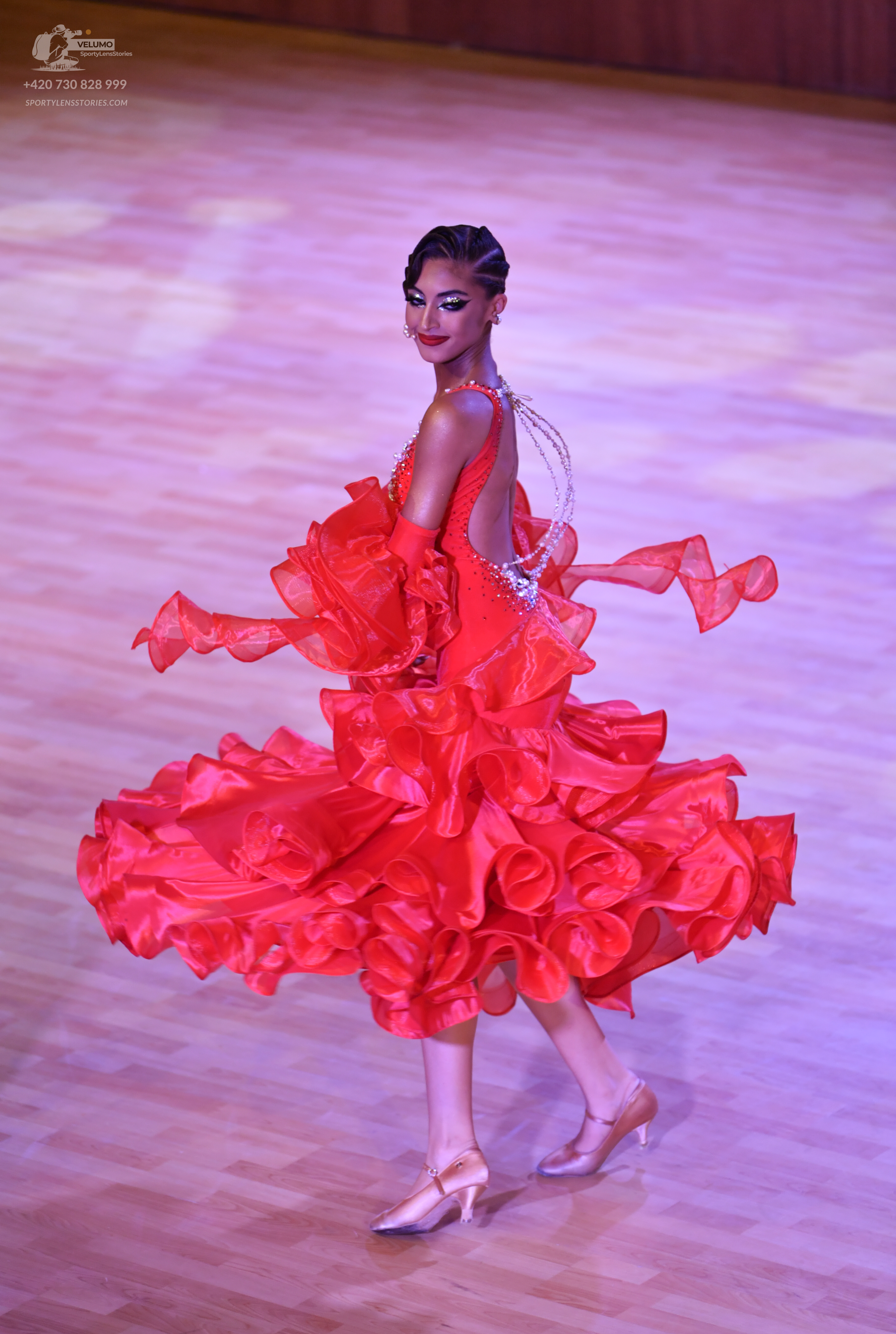 Dancesport competitor: Female dancer: red latin dress with voluminous ruffles