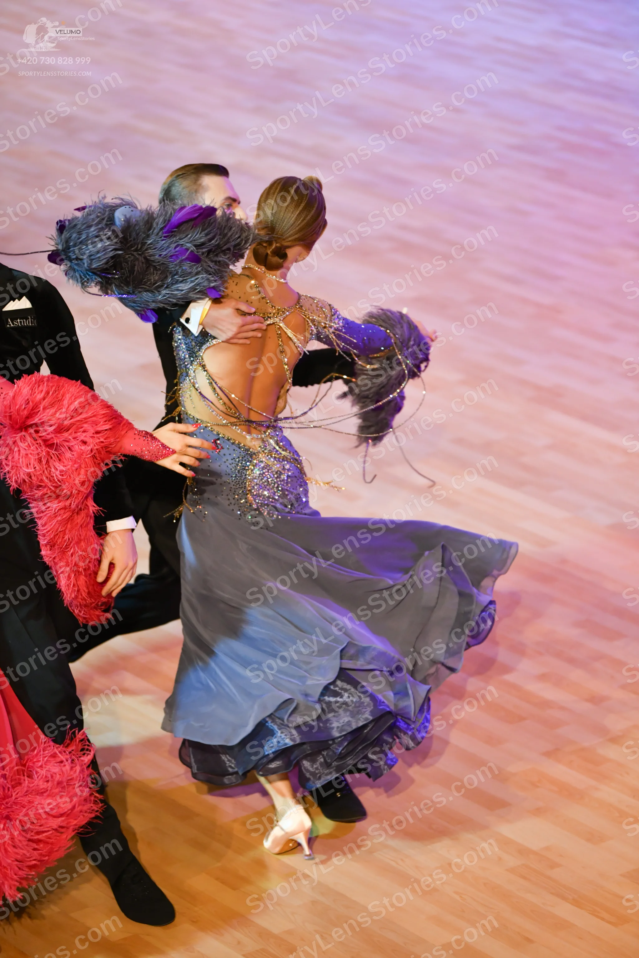 Dancesport competitor: Male:** Black tail suit with silver sequin lapels and a wide black bow tie