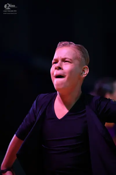 Dancesport competitor: Male dancer: black V-neck shirt under a black open jacket