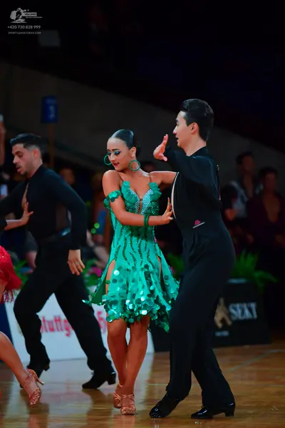 Dancesport competitor: Male dancer (left): black long-sleeved shirt and trousers
