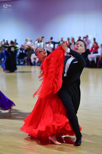 Dancesport competitor: Male dancer: black suit with a white shirt
