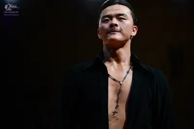 Dancesport competitor: Male dancer: black long-sleeved shirt, unbuttoned at the chest, with a silver ch