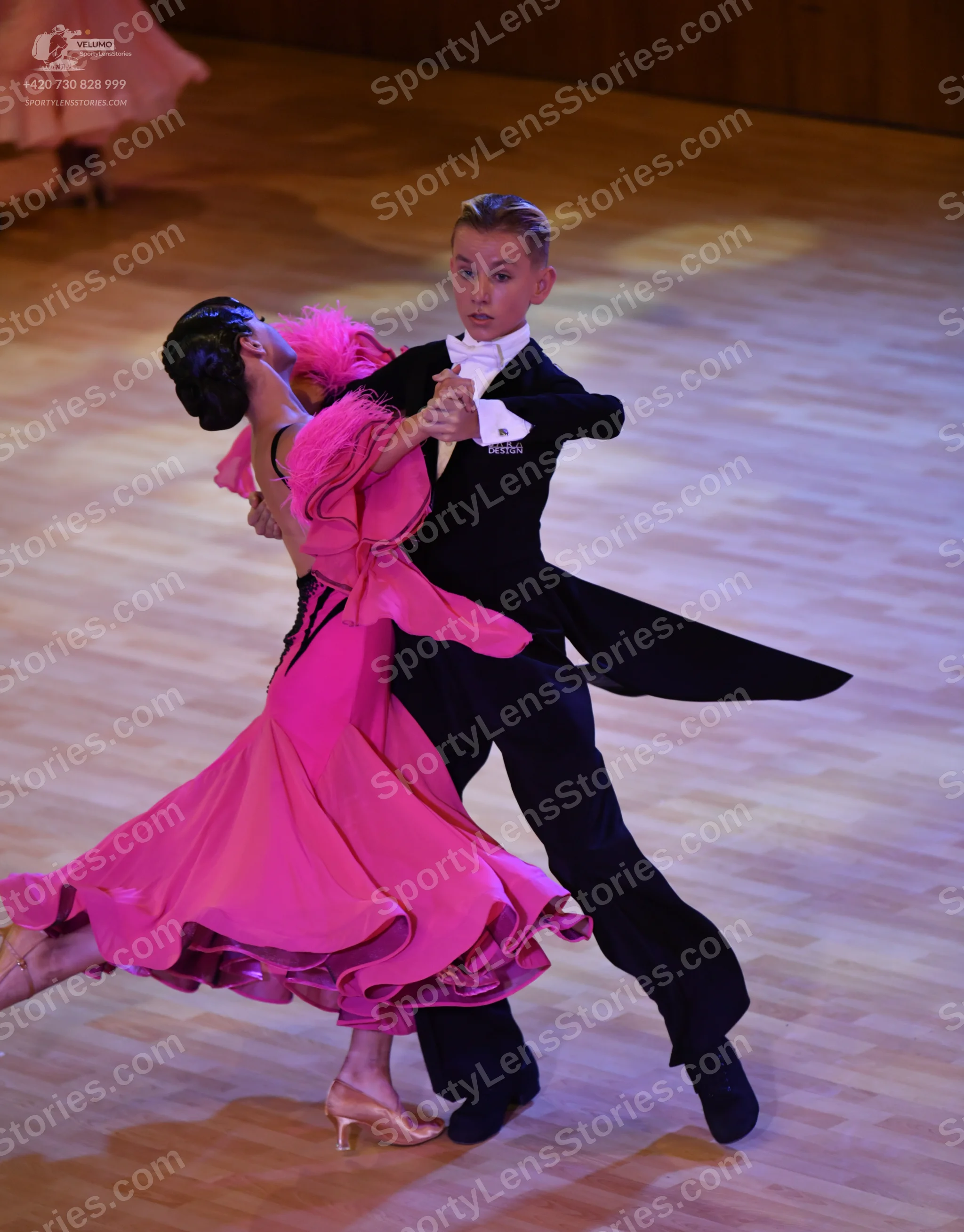 Dancesport competitor: ** Black tailsuit with pink sequin details on the lapels and trim