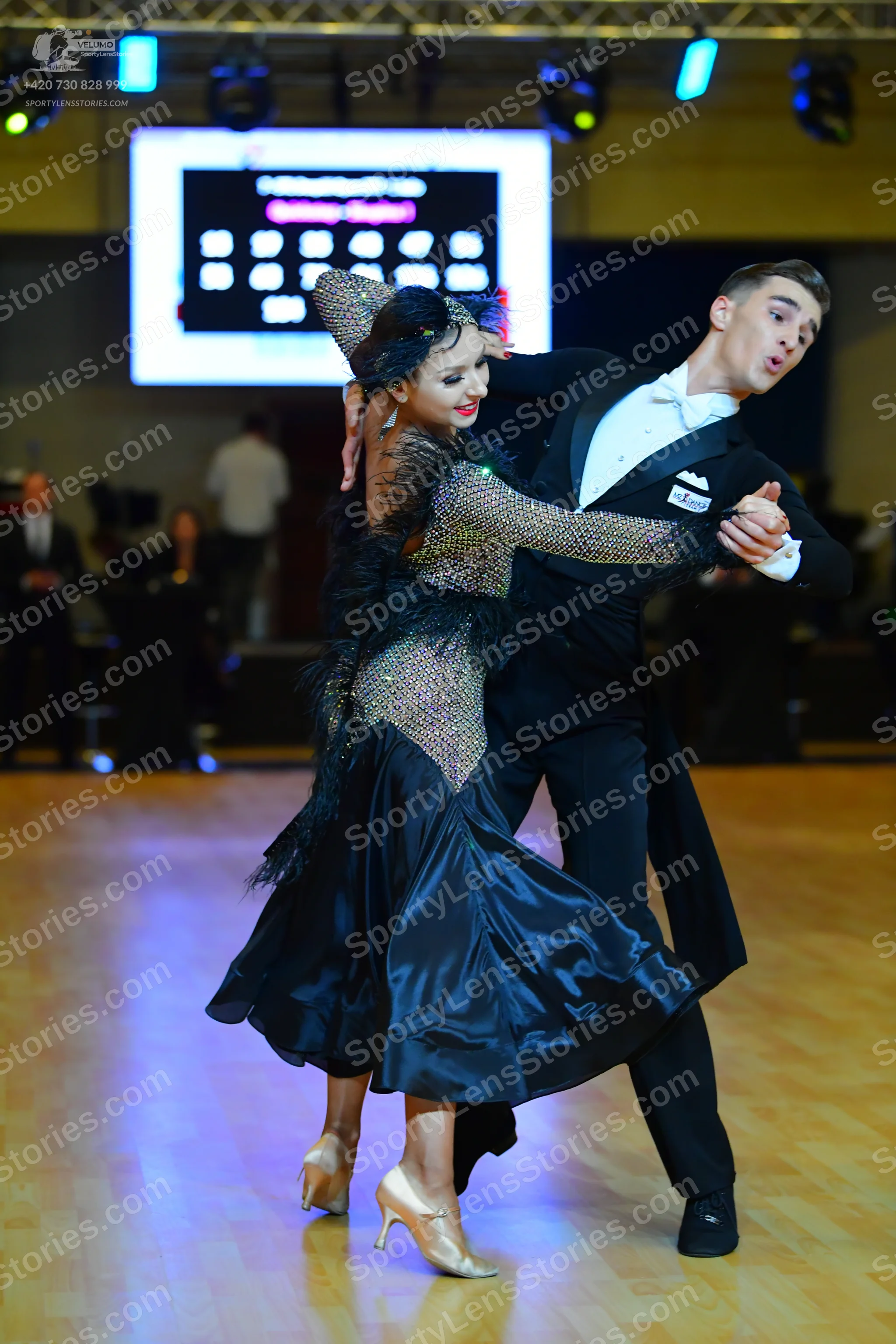 Dancesport competitor: Male dancer: black suit with a white shirt and white bow tie