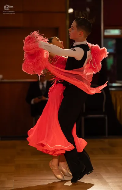 Dancesport competitor: Male dancer: white long-sleeved shirt with black details and black trousers