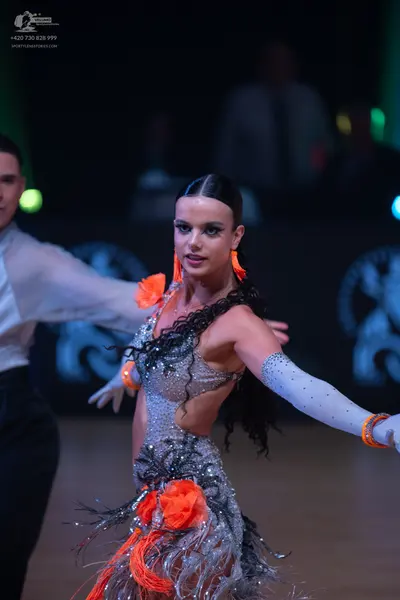 Dancesport competitor: Male dancer: white long-sleeved shirt and black trousers