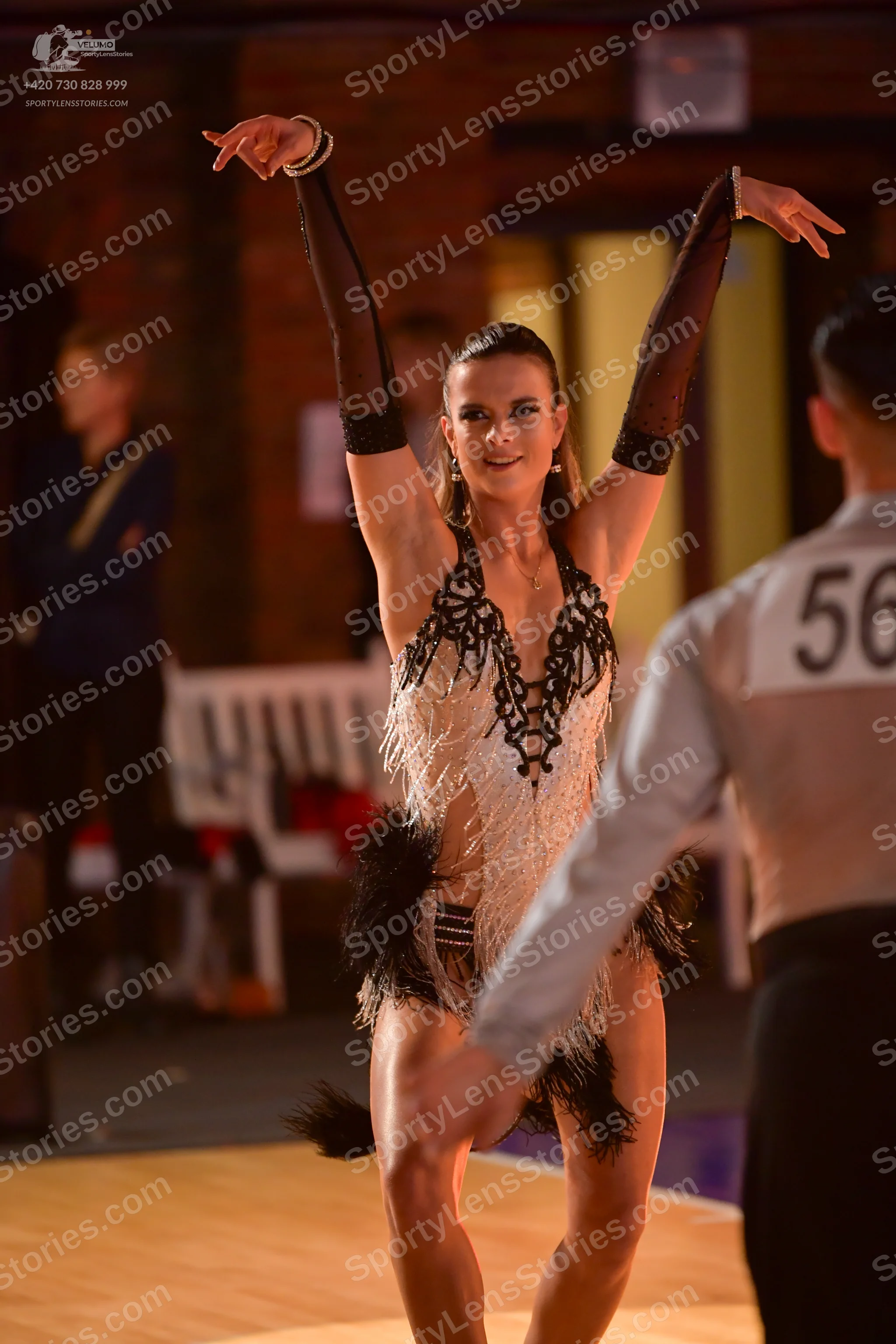 Dancesport competitor #56: Female dancer: white and black Latin dance costume with a patterned bodice, shee