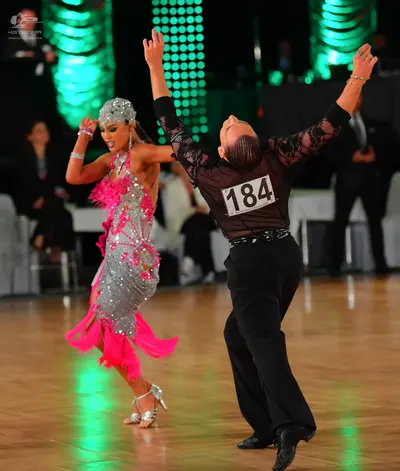 Dancesport competitor #184: Male dancer: black long-sleeved shirt with black lace/sequin patterns and black 