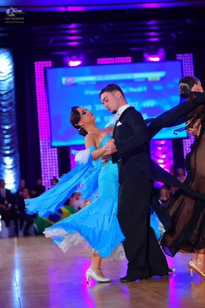 Dancesport competitor: Male dancer: black suit with a white shirt and white pocket square