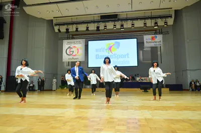 Dancesport competitor: Female dancers: white long-sleeved blouses and black trousers/leggings