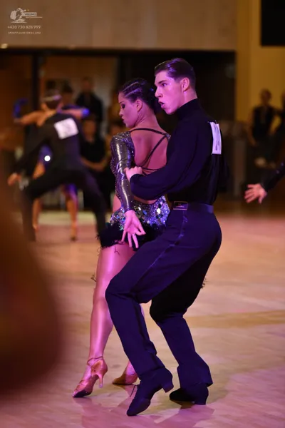 Dancesport competitor: Male dancer: black long-sleeve shirt and black trousers