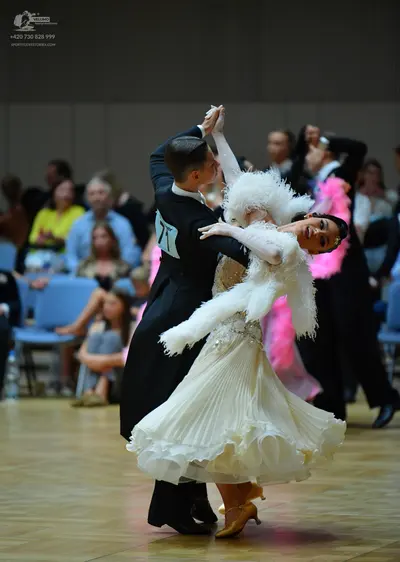 Dancesport competitor: Male dancer: black suit with a white shirt