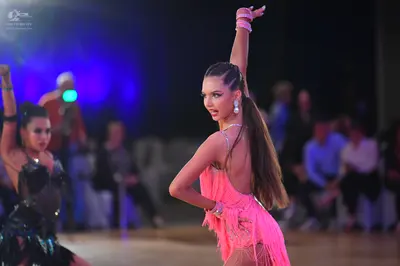 Dancesport competitor: Female dancer 1: pink latin dress with fringe and thin straps