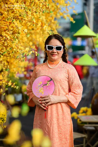 Dancesport competitor: Female dancer: peach-colored long-sleeved traditional dress with a subtle floral