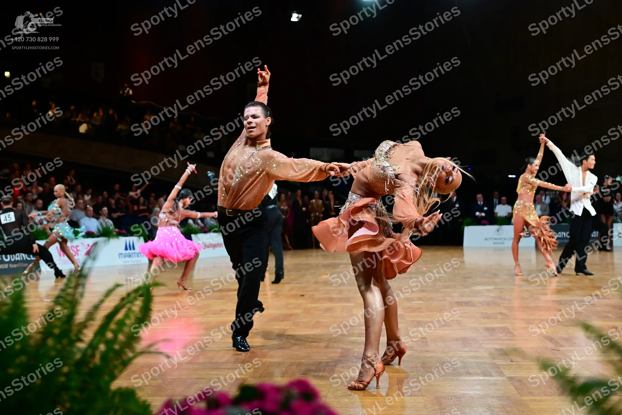 Dancesport competitor: Male dancer (center): champagne-colored long-sleeve shirt and black trousers
