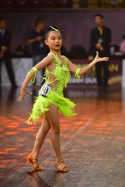 Dancesport competitor #30: Female dancer: bright lime green Latin dress with long fringe, sequin embellishm