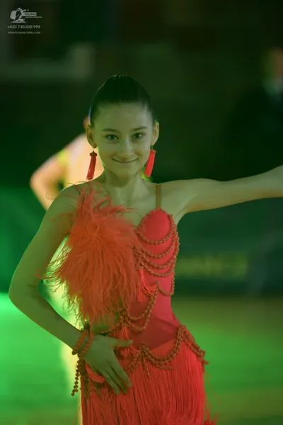 Dancesport competitor: Female dancer: red latin dress with fringe and beaded details