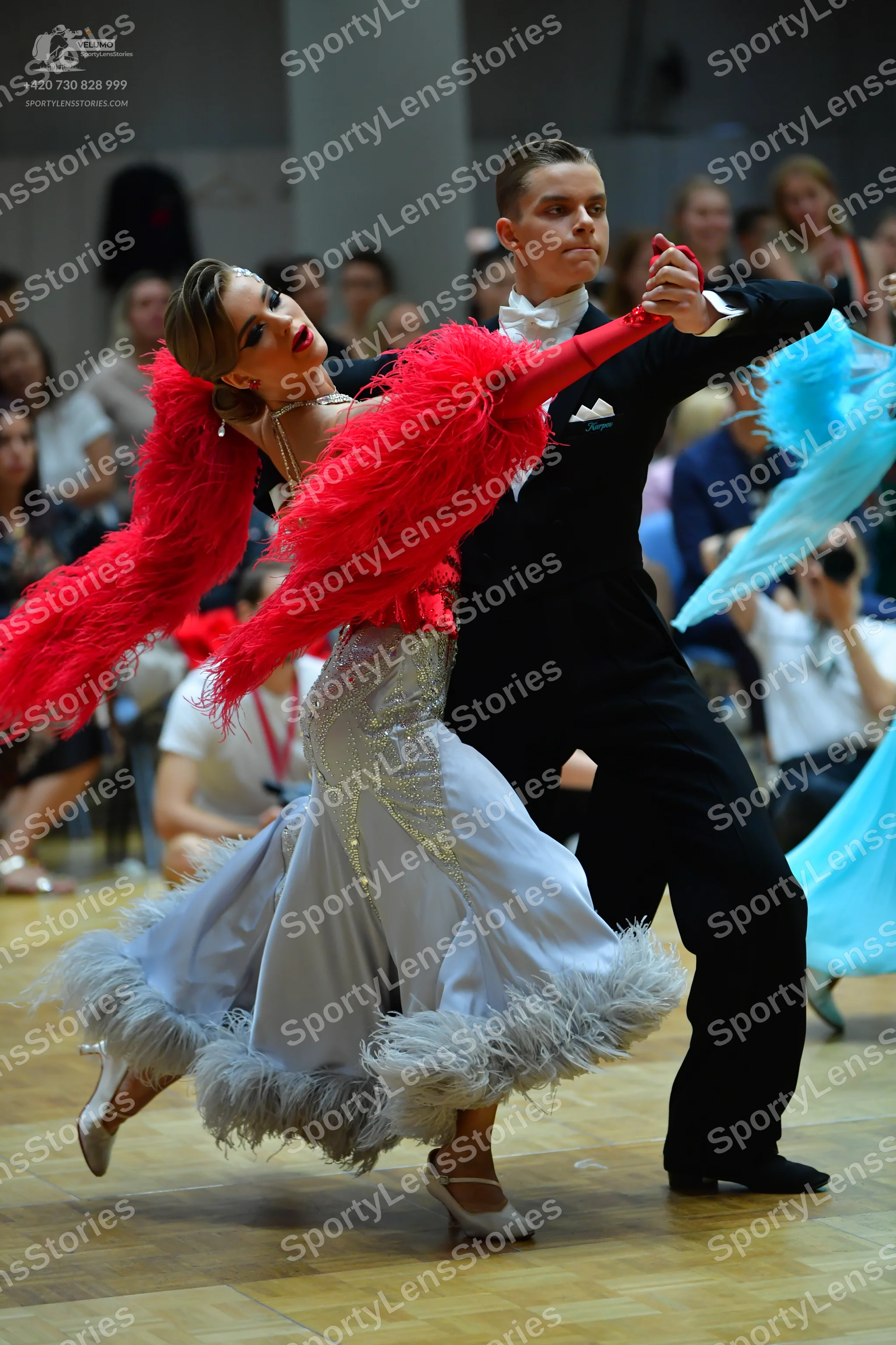 Dancesport competitor: Male dancer: black suit with a white shirt, white bow tie, and a white pocket sq