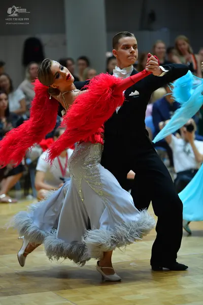 Dancesport competitor: Male dancer: black suit with a white shirt, white bow tie, and a white pocket sq