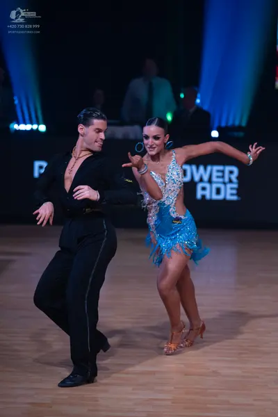 Dancesport competitor: Male dancer: black long-sleeved shirt and black trousers with a thin sparkly str