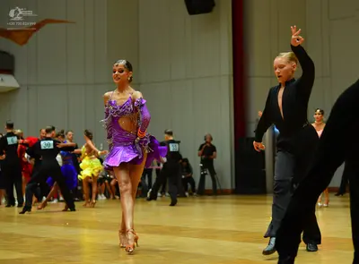 Dancesport competitor: Main female dancer: purple Latin dress with sequins, lace, and ruffles