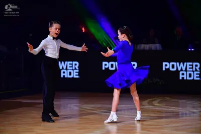 Dancesport competitor: Male dancer: white long-sleeved shirt with a black bowtie and black trousers