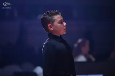 Dancesport competitor: Male dancer: black long-sleeved shirt