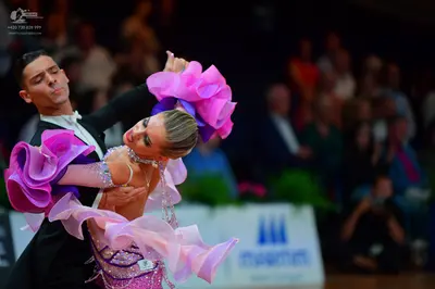 Dancesport competitor: Male dancer: black suit with a white shirt and white bow tie