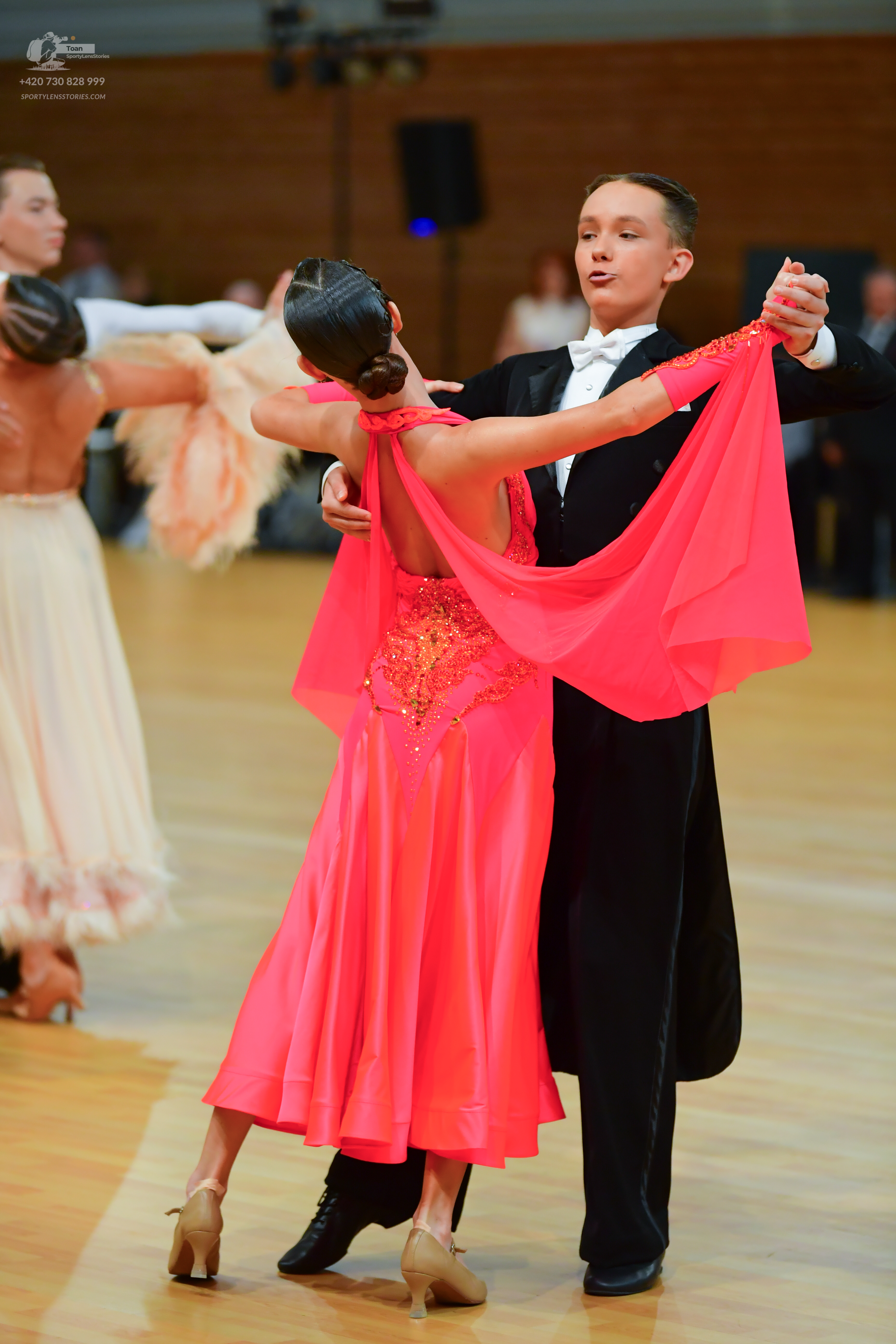 Dancesport competitor: Male:** Black tail suit with satin lapels, black leather shoes with gold heels
