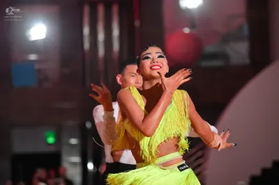 Dancesport competitor: Female dancer: yellow/lime green Latin dance costume with fringe