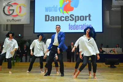 Dancesport competitor: Male dancer: blue blazer with a textured pattern, white shirt, and black trouser