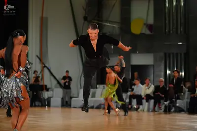 Dancesport competitor: Female dancer (foreground): silver sequined Latin dress with fringe