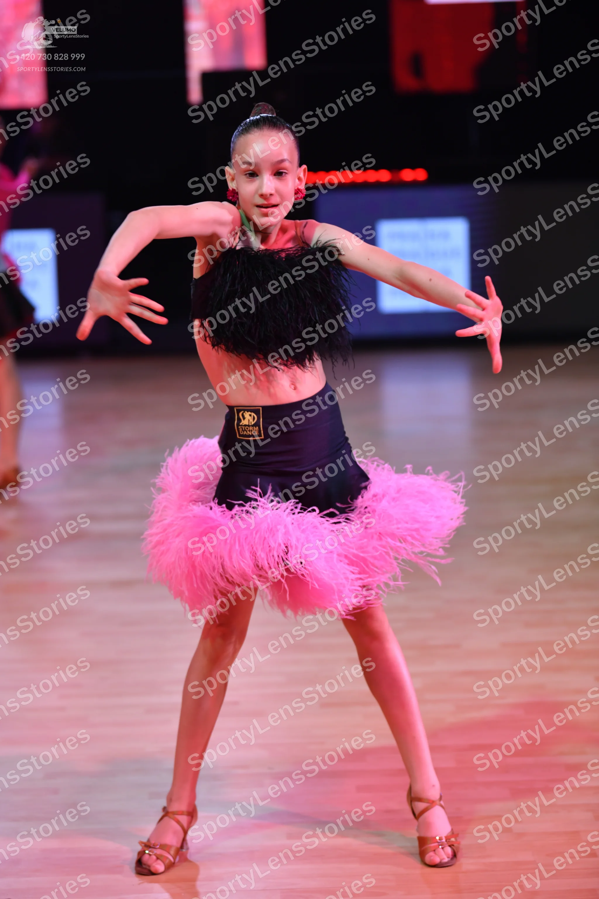 Dancesport competitor: Female dancer: black crop top with textured black fringe, black high-waisted sho
