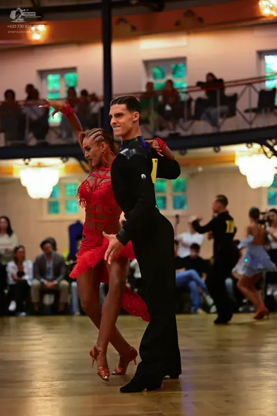 Dancesport competitor: Male dancer: black long-sleeved shirt and black trousers