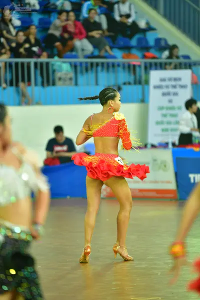 Dancesport competitor: Female** (all dancers are female in this photo)

*   **Color:** Primarily bright