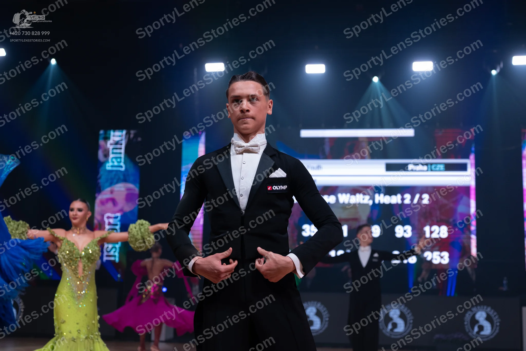 Dancesport competitor: Male dancer: black suit with white shirt, white bowtie, and white pocket square