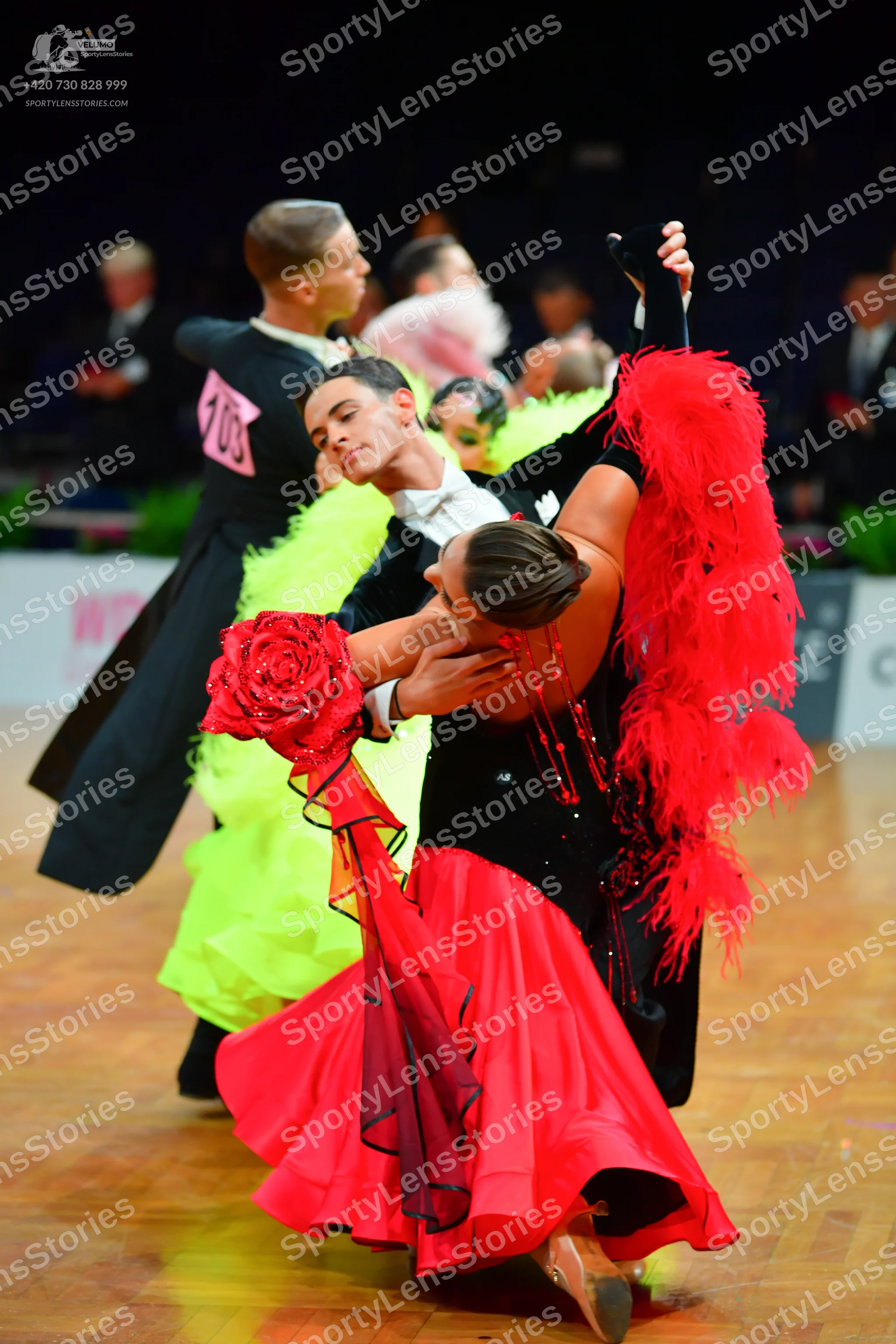 Dancesport competitor: Male dancer (foreground): black suit with a white shirt
