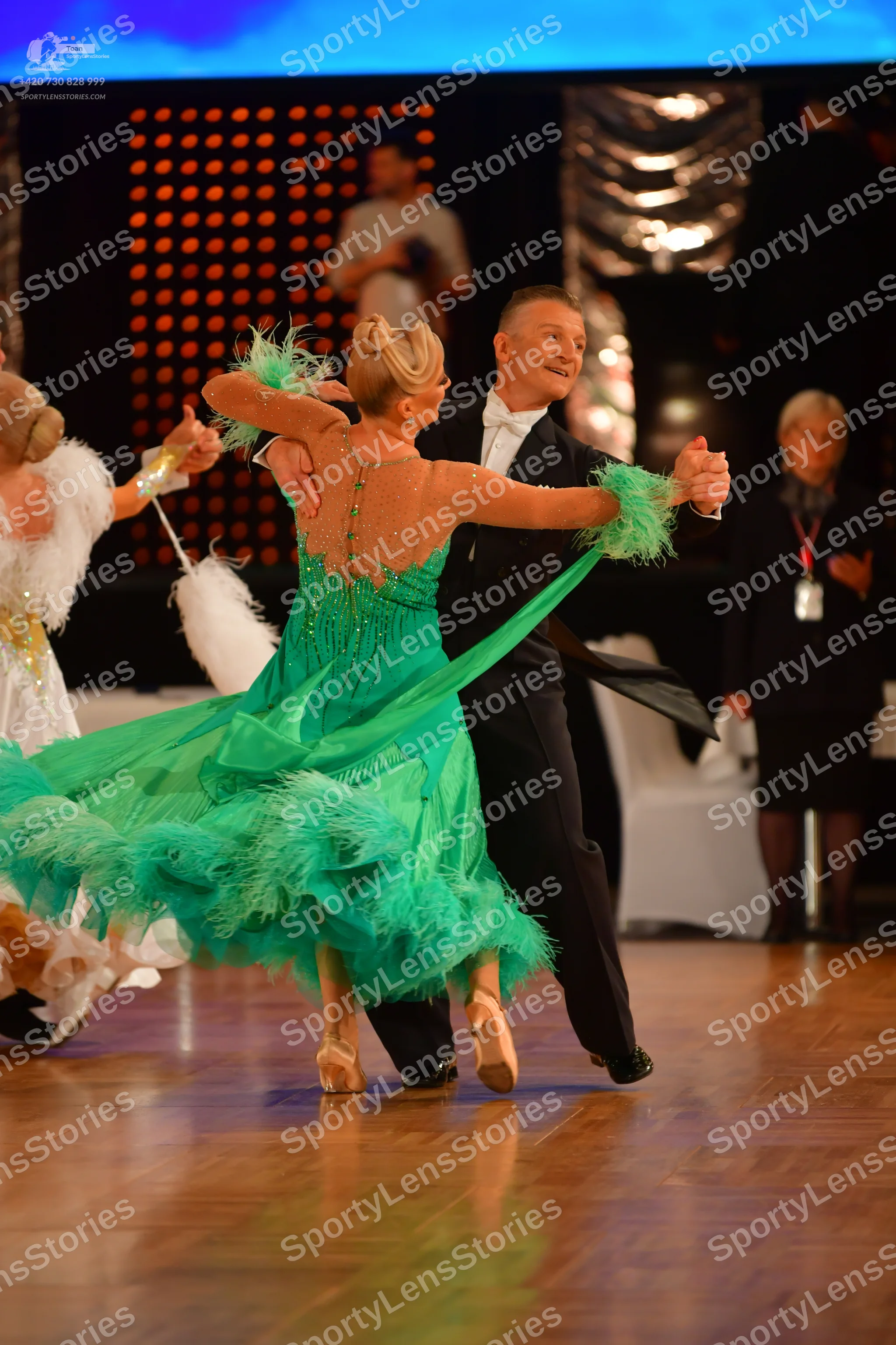 Dancesport competitor: Female dancer 1: green Latin dress with fringe and sequins