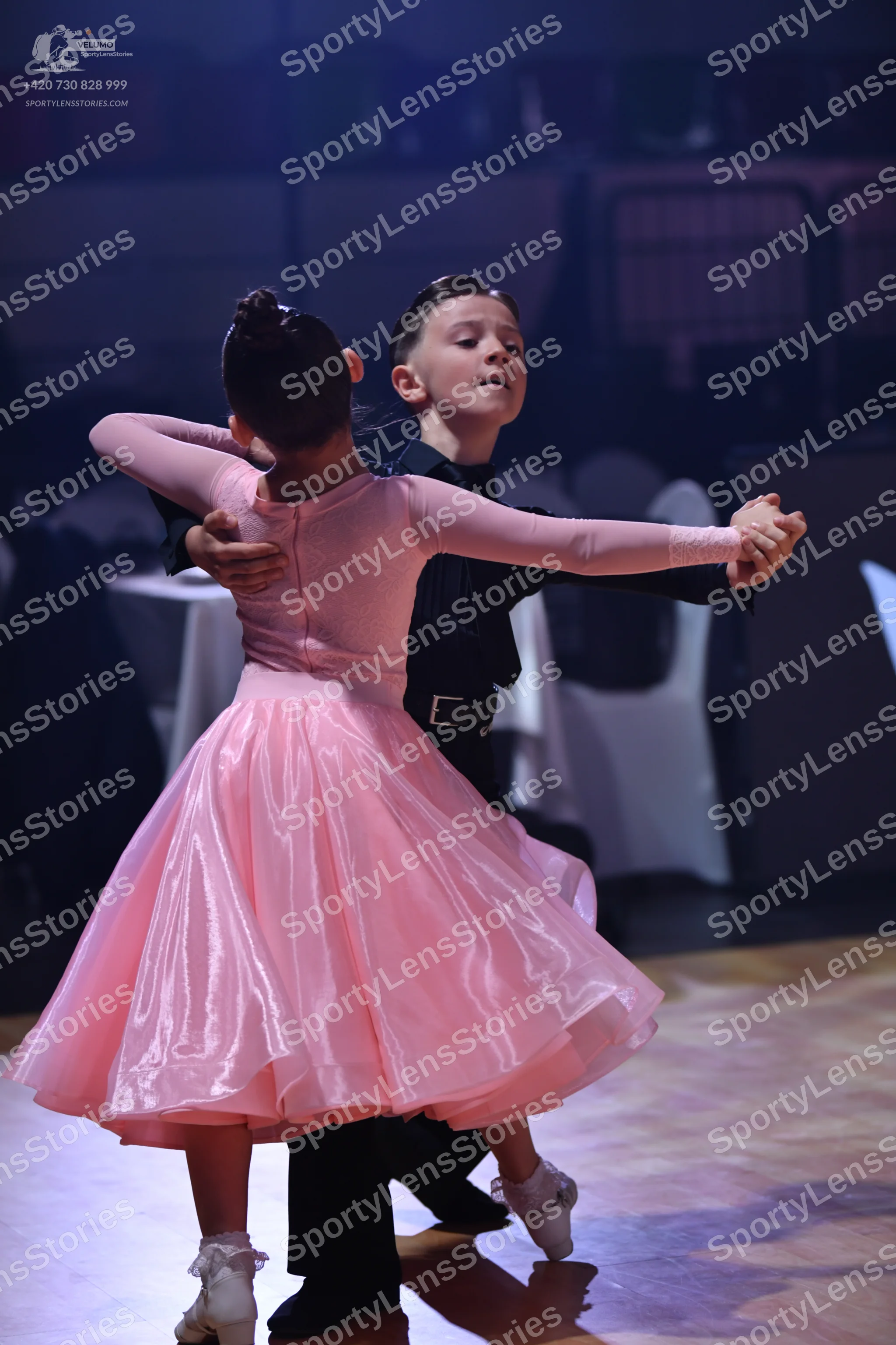 Dancesport competitor: Female dancer: pink ballroom dress with long sleeves and a voluminous satin skir