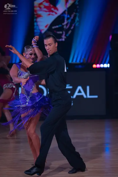 Dancesport competitor: Male dancer: black long-sleeved shirt and black trousers